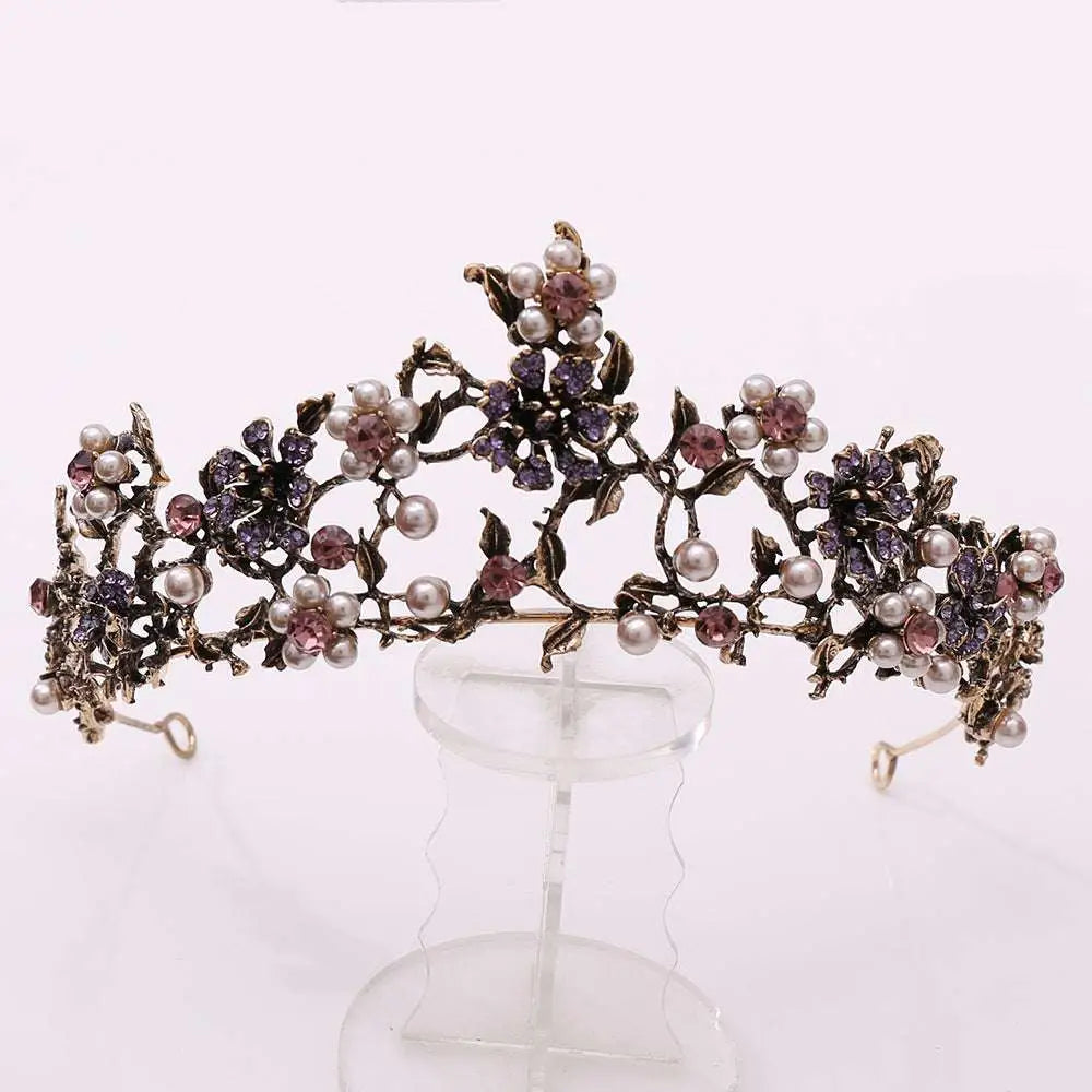 An ornate floral black diamond pearl baroque bridal crown with white pearls and purple pink gemstone floral design