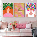 Three colorful framed floral botanical nordic girls wall art canvas prints hang above a sofa with inspirational quotes