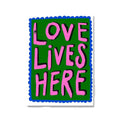 A vibrant green floral botanical nordic girls wall art canvas print with a scalloped blue border and bold pink love lives here text