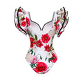 A white chiffon polyester printed one piece swimsuit with vibrant red and pink poppies and black ruffled trim straps