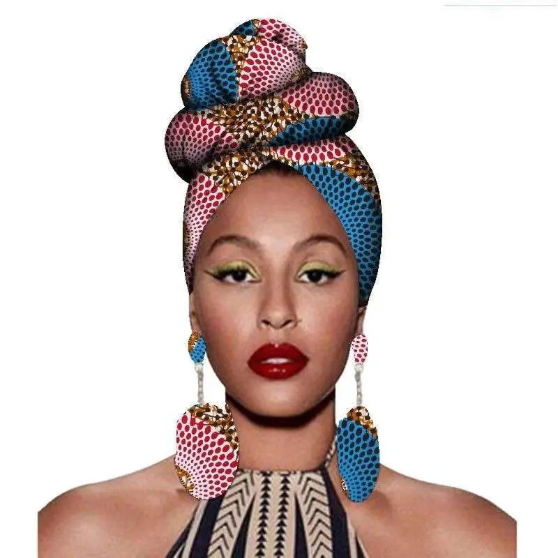 A vibrant fashion african headscarf in bold pink and blue with gold accents paired with earrings set