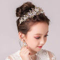 Delicate gold-toned princess crown tiara with intricate floral design featuring clear and soft pink crystals