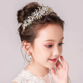Delicate gold-toned princess crown tiara with an intricate floral design adorned with clear and soft pink crystals