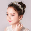 Delicate gold-toned princess crown tiara with intricate floral design featuring clear and soft pink crystals