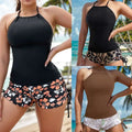 Black floral halterneck printed halter bikini with fitted halter top and matching orange white hibiscus shorts