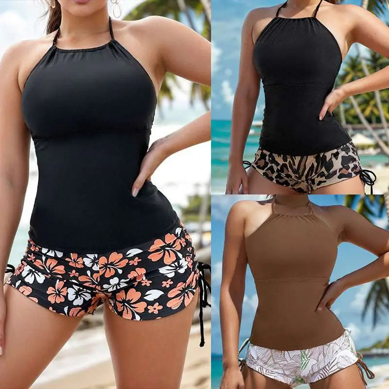 Black floral halterneck printed halter bikini with fitted halter top and matching orange white hibiscus shorts
