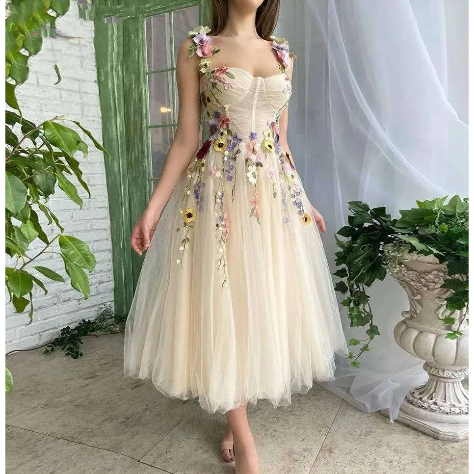 Delicate off-white champagne tulle prom dress with intricate multi-hued floral appliqués on bodice and skirt