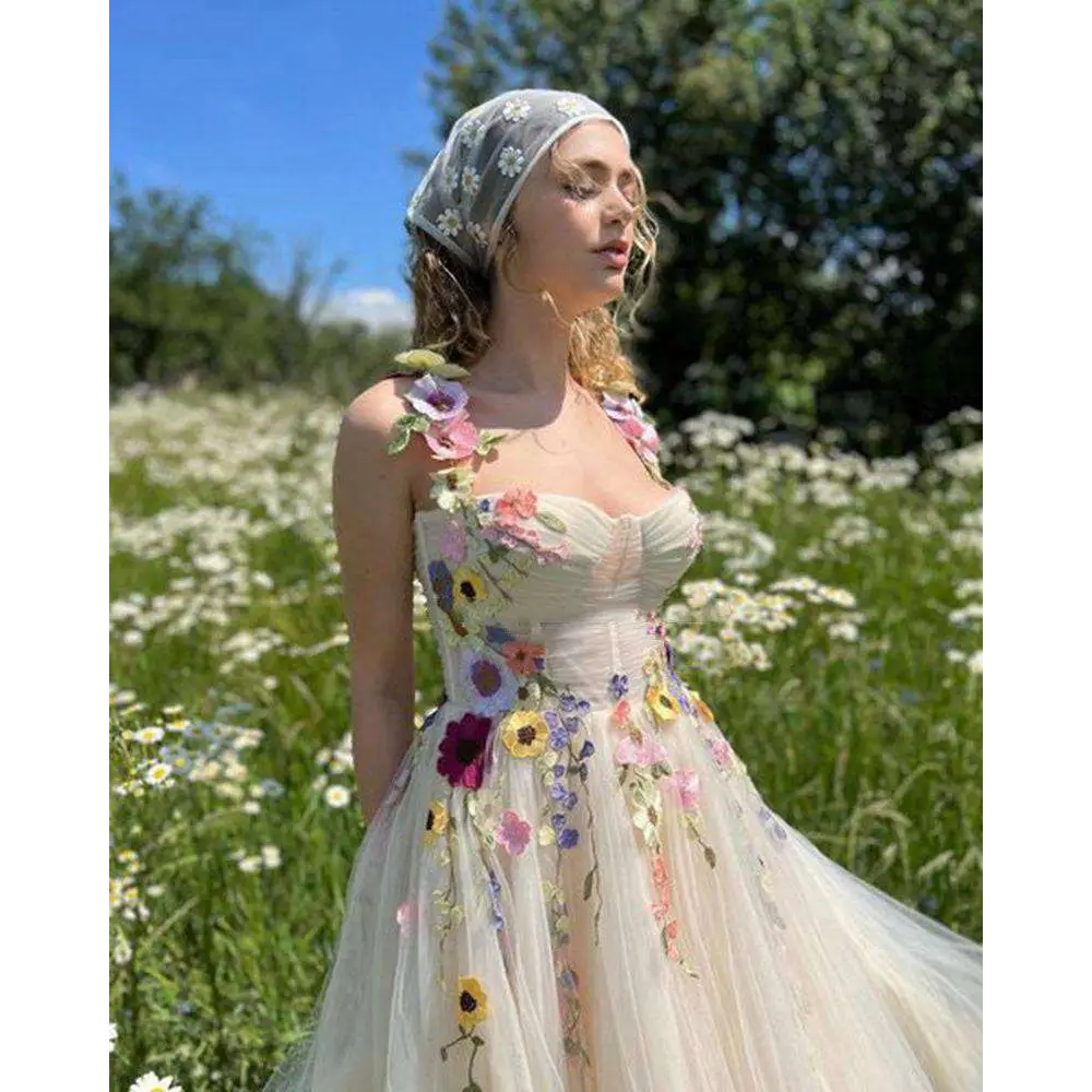 Delicate off-white champagne tulle prom dress with vibrant three-dimensional floral appliqués in pink yellow purple and orange