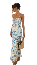 White floral print maxi dress with delicate blue flowers, thin spaghetti straps, and a ruffled swing skirt hemline