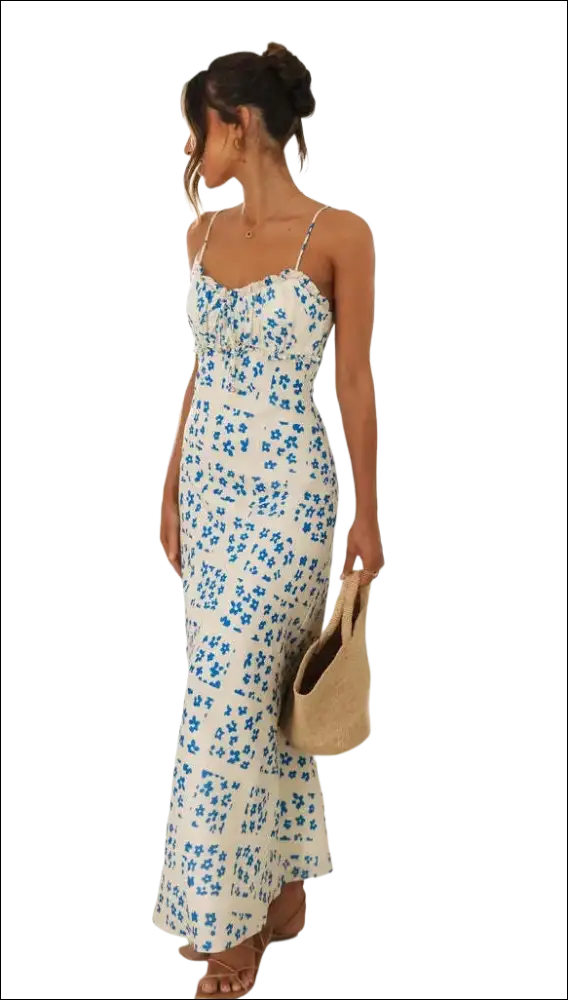 White floral print maxi dress with delicate blue flowers, thin spaghetti straps, and a ruffled swing skirt hemline