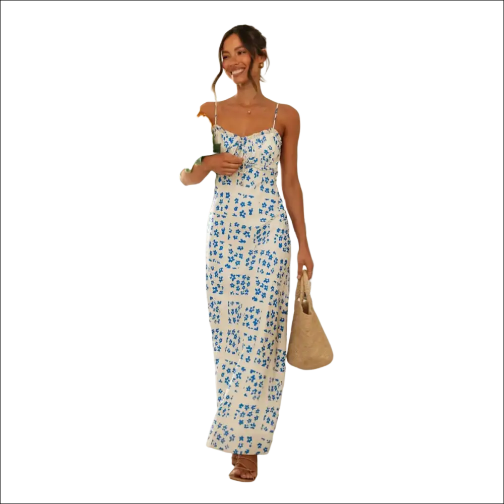 White floral print maxi dress with delicate blue pattern, thin spaghetti straps, and a flowing swing skirt