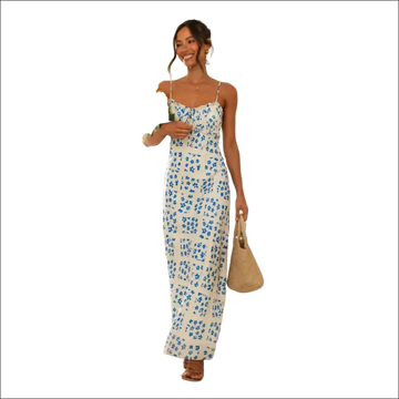 White floral print maxi dress with delicate blue pattern, thin spaghetti straps, and a flowing swing skirt