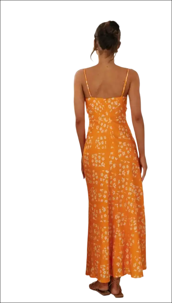 A vibrant orange floral print maxi dress with a delicate white pattern, thin spaghetti straps, and a flowing swing skirt