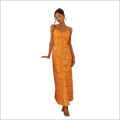 A vibrant orange floral print maxi dress with thin spaghetti straps and a ruched bodice featuring a swing skirt