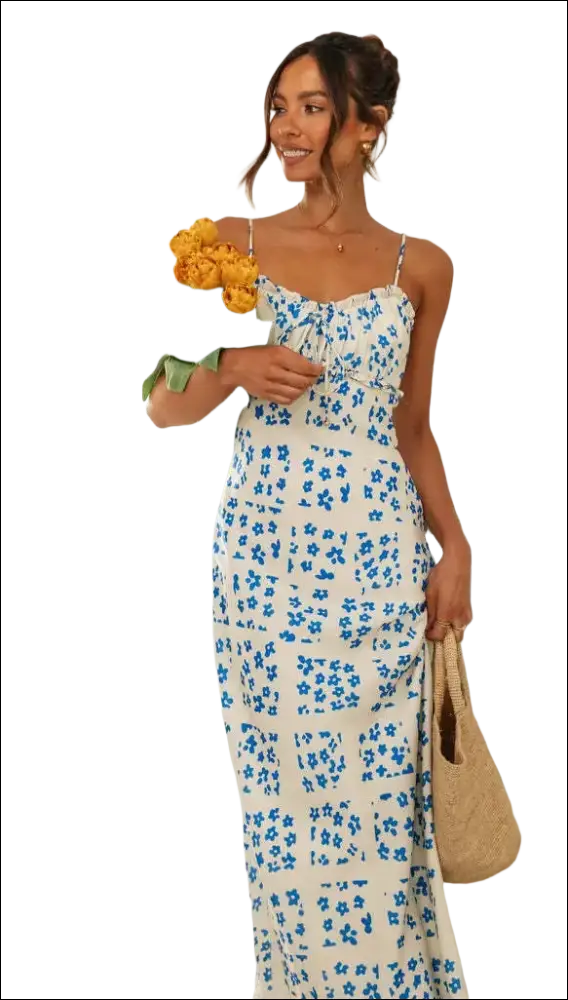 A woman wears a white floral print maxi dress with blue flowers and a swing skirt with thin spaghetti straps
