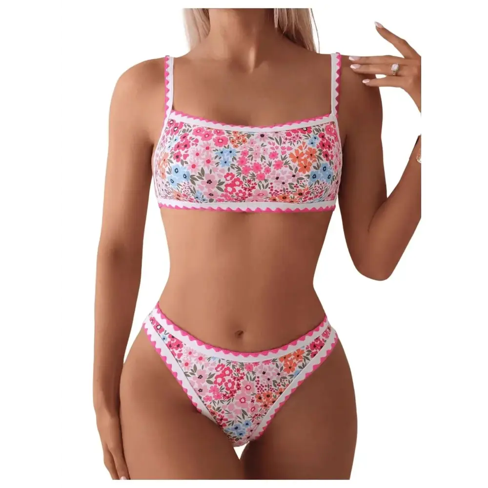 Floral scalloped women two piece bathing suit with vibrant pink blue and orange floral print and scalloped edges