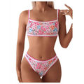 A floral scalloped women two piece bathing suit featuring vibrant pink blue and orange blossoms on white fabric