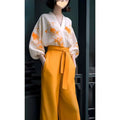 White floral silk slimming blouse with orange embroidery and voluminous sleeves paired with mustard yellow flab hiding shirt set trousers