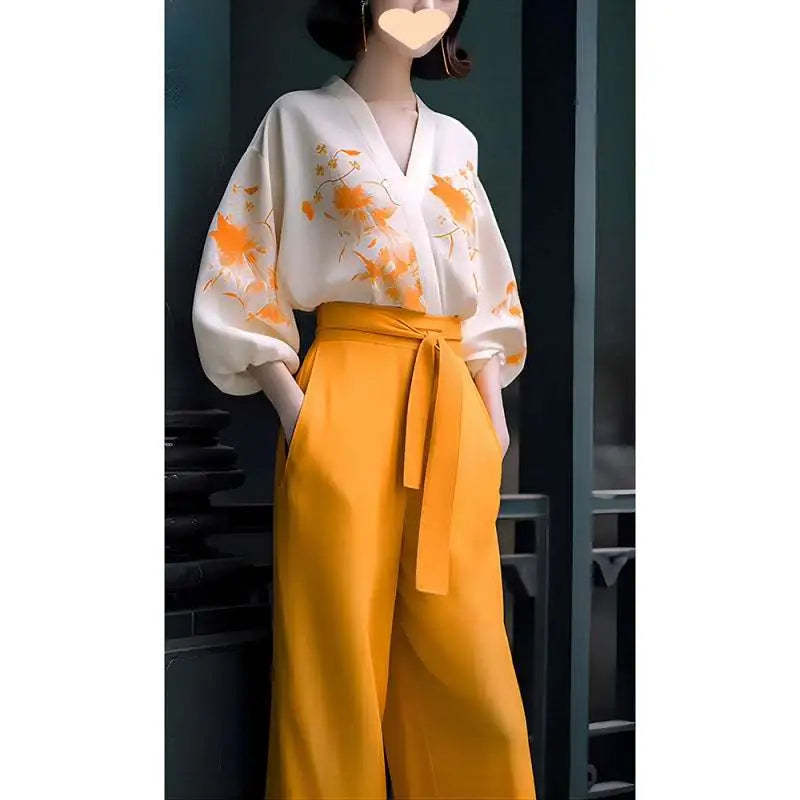White floral silk slimming blouse with orange embroidery and voluminous sleeves paired with mustard yellow flab hiding shirt set trousers