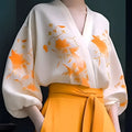 A flowing white floral silk slimming blouse with vibrant orange embroidery made from lightweight fabric hiding flab