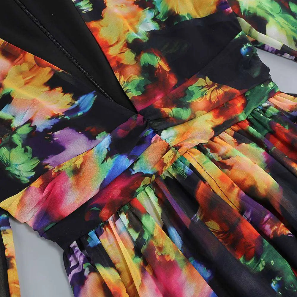 A vibrant floral v-neck split comfort casual dress with bold oranges purples and greens on a black background