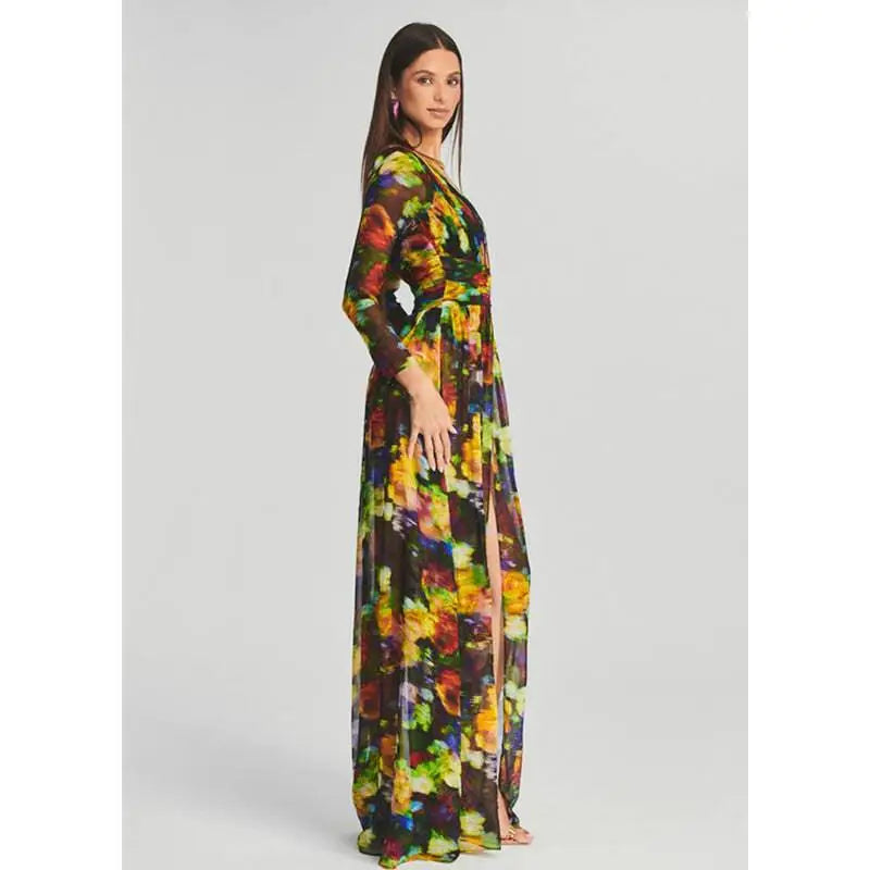 A floral v-neck split comfort casual dress featuring long sleeves and bold yellow and green floral print on dark fabric