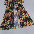A flowing long-sleeved black maxi floral v-neck split comfort casual dress with vibrant floral print fabric