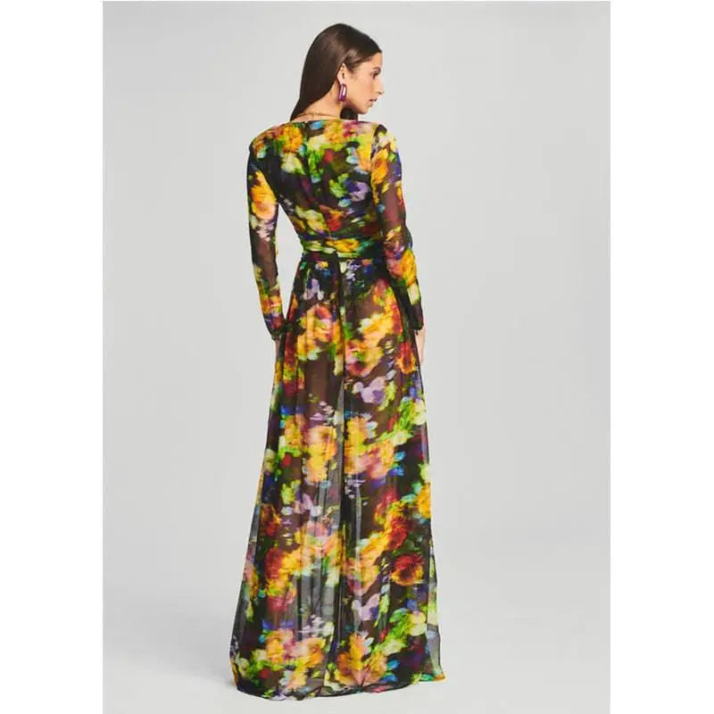 A flowing long-sleeved floral v-neck split comfort casual dress with vibrant yellow orange green and purple flowers on dark background