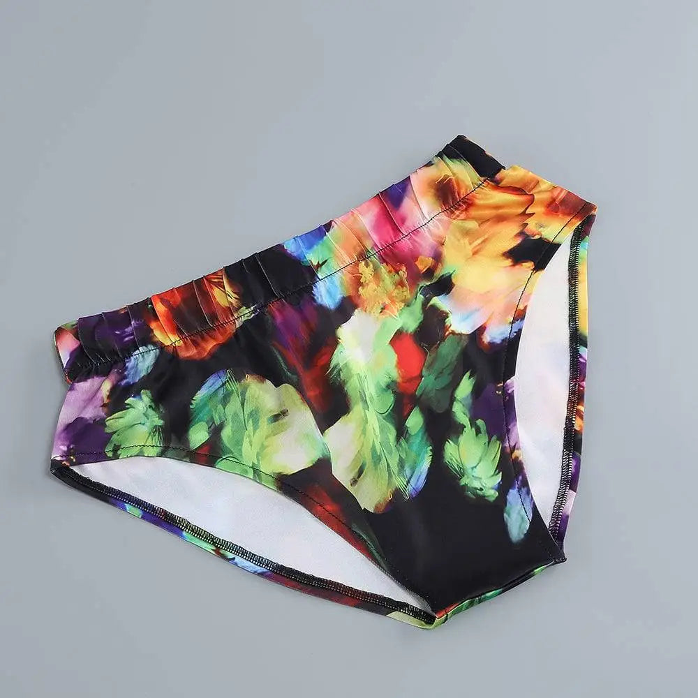 Floral v-neck split comfort casual dress featuring vibrant swim trunks with black base and colorful abstract blooms