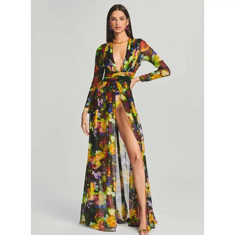 A flowing long-sleeved maxi floral v-neck split comfort casual dress with vibrant yellow green purple and orange print on dark background