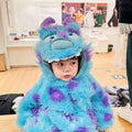 A child wearing a fluffy monster cute blue and purple furry baby jumpsuit with large eyes and ears animal baby jumpsuit