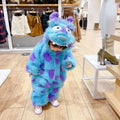 A child wearing a fluffy monster cute blue and purple sully animal baby jumpsuit perfect for infants and toddlers