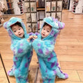 Two toddlers in matching fluffy blue and purple monster cute animal baby jumpsuits with large ears and tails