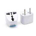 White plastic travel adapter with multiple metallic pins designed for small quick dryer with circular control panel and gray fabric
