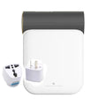 White and gray travel adapter with gold accent and multiple plug configurations for small quick dryer use with gray fabric