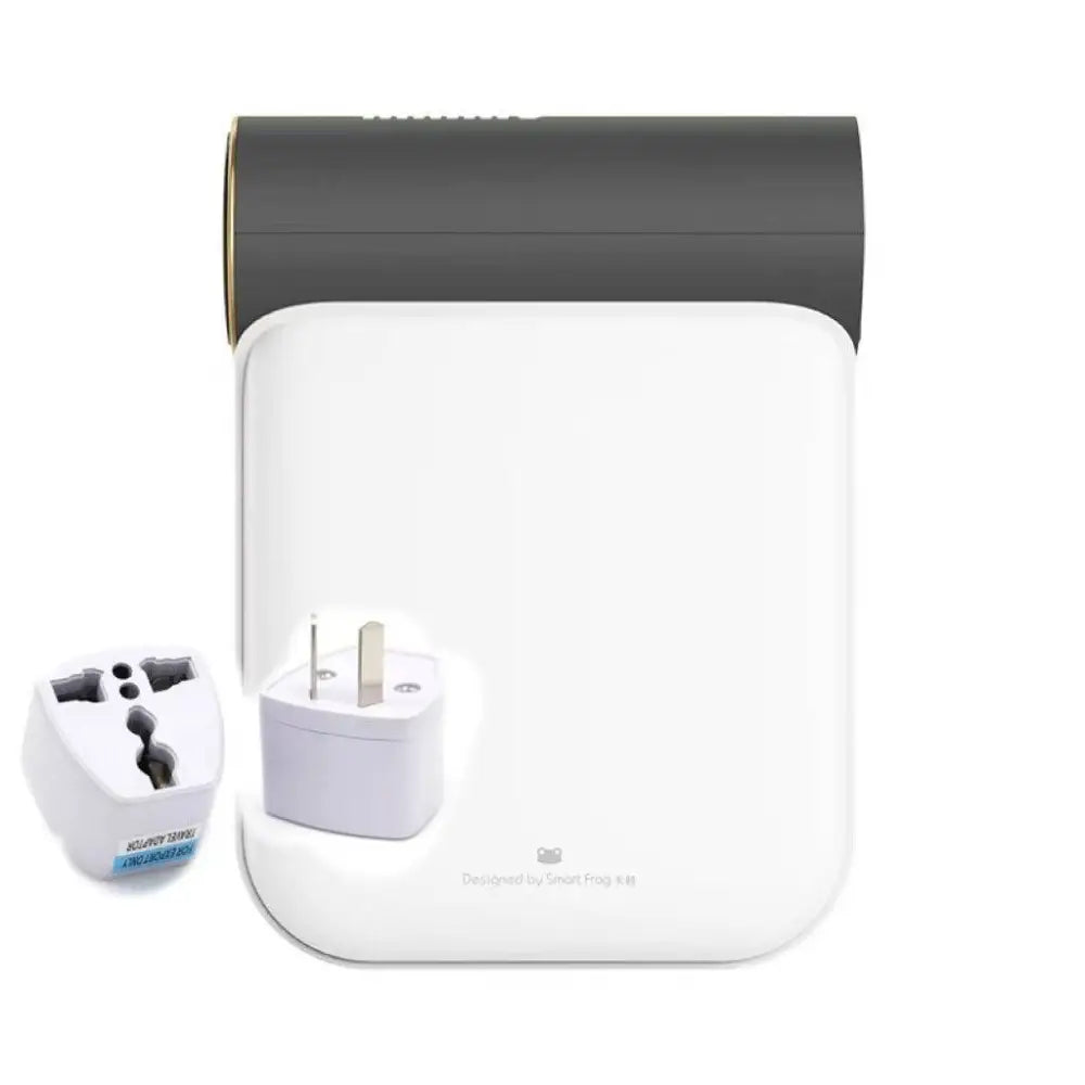 White and gray travel adapter with gold accent and multiple plug configurations for small quick dryer use with gray fabric
