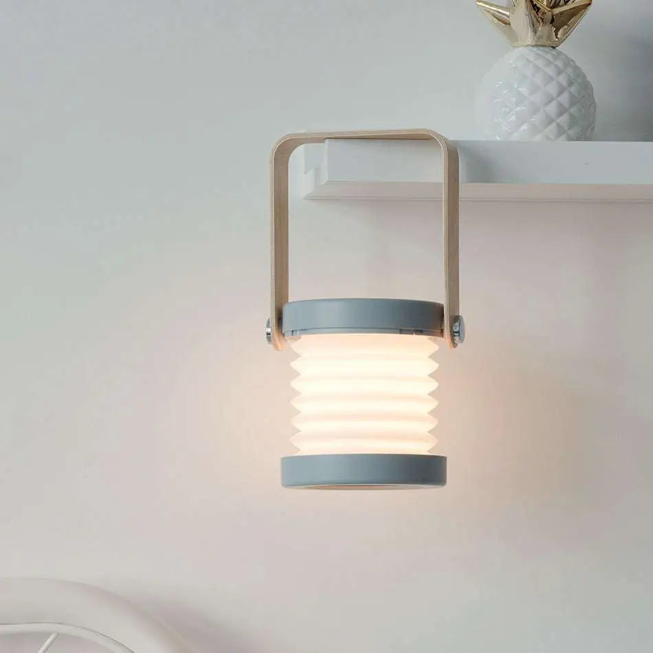 A modern gray foldable touch dimmable portable lantern wall light with soft white glow for reading and night use