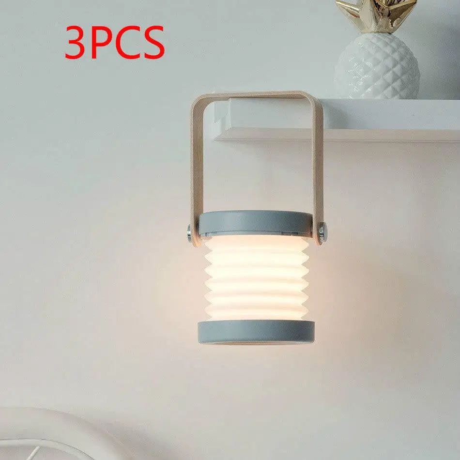 Gray foldable touch dimmable portable lantern with wooden handle emitting soft warm light for reading and night use