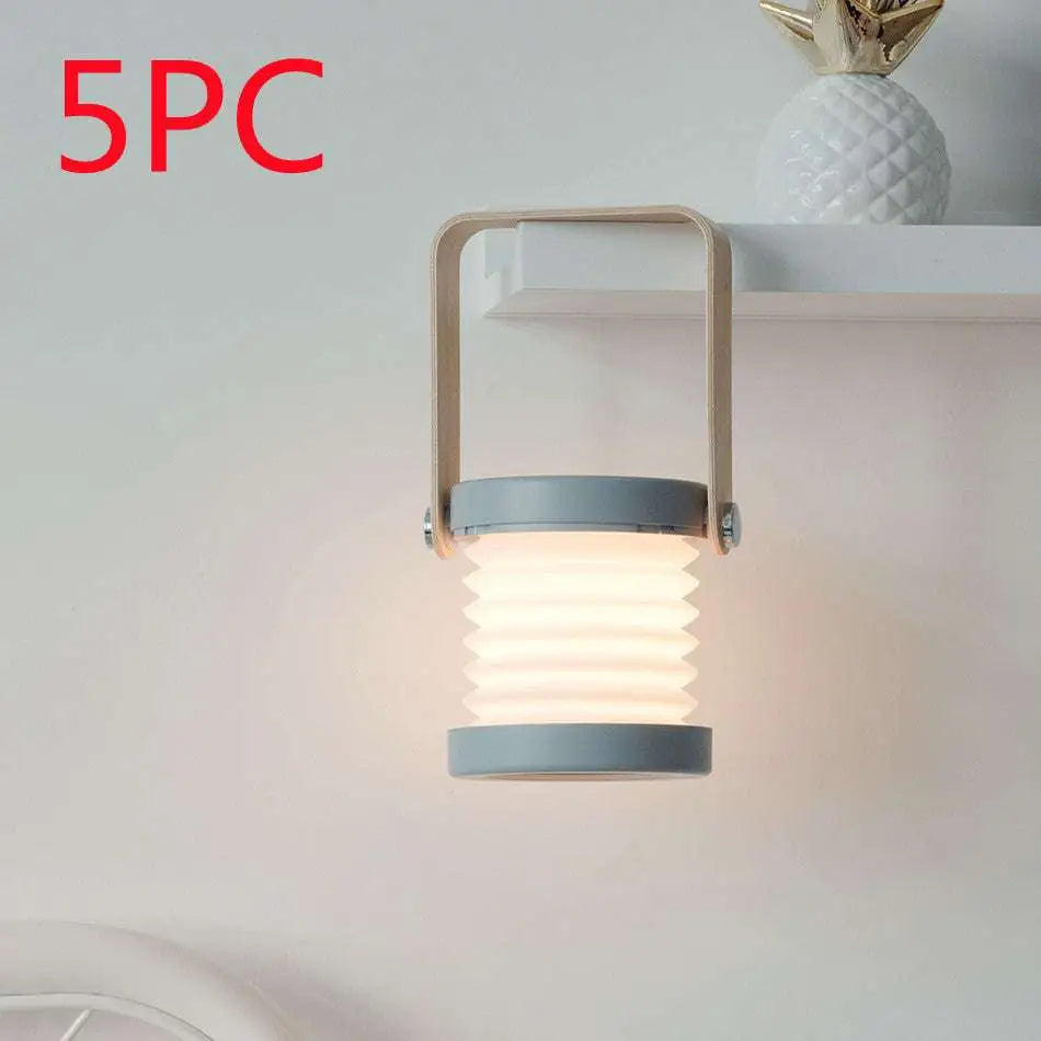 Gray foldable touch dimmable portable lantern with metallic handle emitting warm diffused light for reading