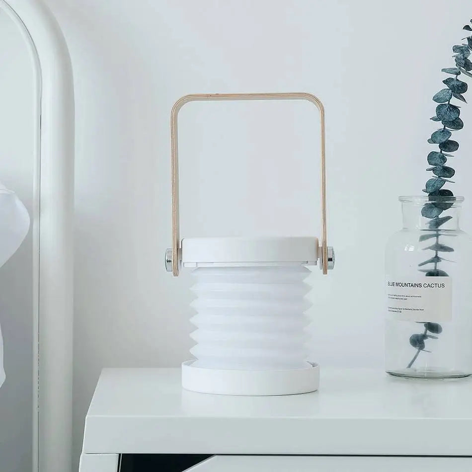 White foldable touch dimmable portable lantern with gold-toned metal handle for touch dimmable reading and night light