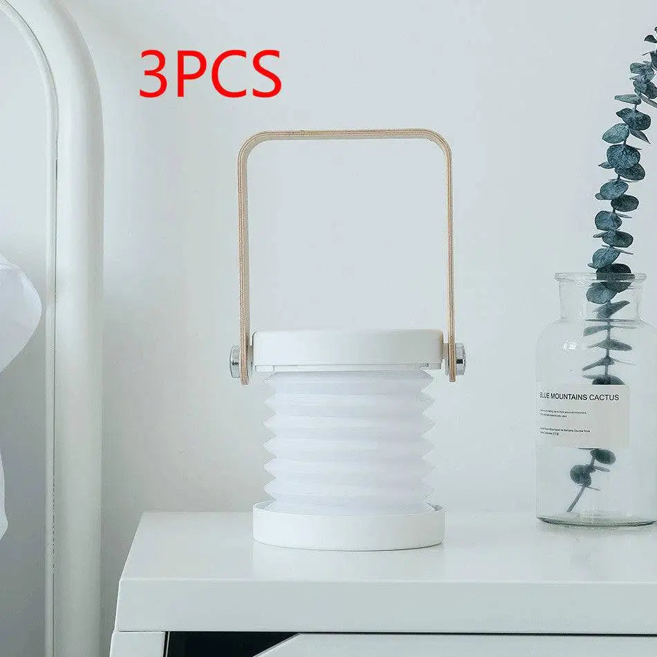 White foldable touch dimmable portable lantern with light wood handle and metallic accents for reading and night light use