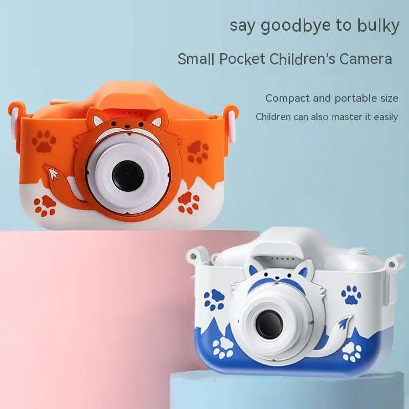 Orange and white fox-themed children’s digital camera with paw print decals and face design paired with blue and white cat model