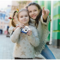 White and blue children’s digital camera with cat face design and paw print decals for playful photography