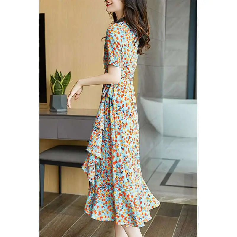 A flowing light blue french floral slim polka dot wrap dress with short sleeves v-neckline and ruffled hem