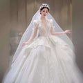A sparkling white wedding gown with intricate beading and yarn long sleeve detailing in french retro bride style