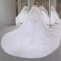 A flowing white french retro bride wedding gown with yarn long sleeve and intricate lace detailing with beaded train