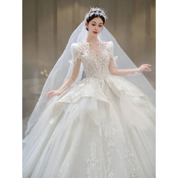 A sparkling white french retro bride wedding gown with yarn long sleeves, intricate beading, lace, and a voluminous skirt