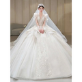 A voluminous ivory french retro bride wedding gown with intricate lace appliqués and yarn long sleeve design