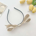 Beige french satin bow headband with a sleek black elastic band, elegant satin bow headbands for women