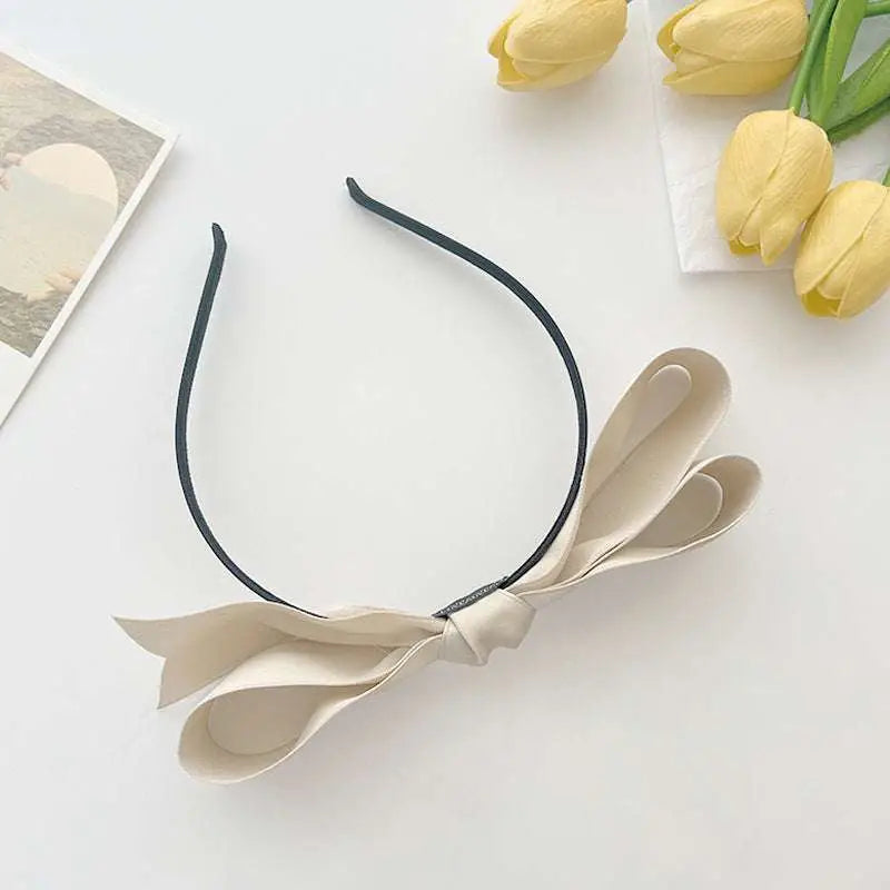 Beige french satin bow headband with a sleek black elastic band, elegant satin bow headbands for women